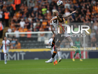 Hull City's Alfie Jones contests a header with Sheffield United's Oliver McBurnie during the Sky Bet Championship match between Hull City an...
