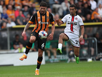 Tobias Figueiredo of Hull City in action with Sheffield United's Iliman Ndiaye during the Sky Bet Championship match between Hull City and S...