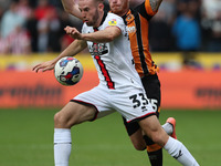 Rhys Norrington-Davies of Sheffield United in action with Hull City's Ryan Woods during the Sky Bet Championship match between Hull City and...