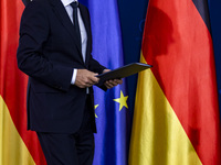 The shadow of German Chancellor Scholz projects on the German flag during the receivement of the winners of the 57. Federal Competition 'Res...