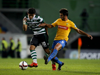 Sporting's forward Fredy Montero (L) vies for the ball with Estoril's midfielder Afonso Taira (R)  during the Portuguese League  football ma...