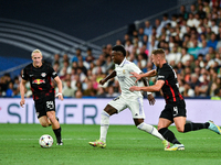 Vinicius Junior, Willi Orban and Xaver Schlager during UEFA Champions League match between Real Madrid and RB Leipzig at Estadio Santiago Be...