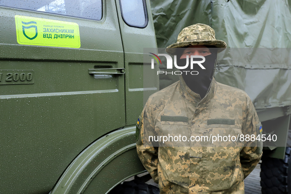 DNIPRO, UKRAINE - SEPTEMBER 20, 2022 - A Ukrainian serviceman stands by one of the heavy-duty trucks that were purchased at the expense of t...