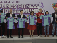 Clara Brugada (in dress), mayor of Iztapalapa in Mexico City, shows a T-shirt during a press conference that will be used in the World's Lar...
