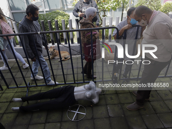 A person observes a mannequin on the floor in the Iztapalapa municipality, Mexico City. (