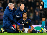 Scotland's Che Adams receives treatment after. colliding with Ukraine's Valeriy Bondar during the UEFA Nations League match between...