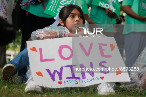A child holds a sign reading 'love wins, HP strong' during a rally near the U.S. Capitol in Washington, D.C. on September 22, 2022 to urge t...