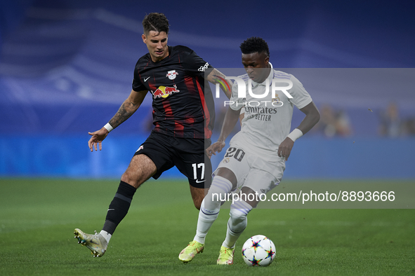 Vinicius Junior left winger of Real Madrid and Brazil and Dominik Szoboszlai attacking midfield of RB Leipzig and Hungary compete for the ba...
