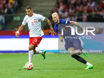 Jakub Kiwior (POL),Wout Weghorst (NED) during the UEFA Nations League match between Poland v Netherlands, in Warsaw, Poland, on September 22...