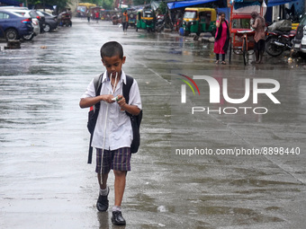 A boy walks back home from his school during a spell of rain in New Delhi, India on September 22, 2022. (