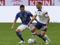 Jordan Morris left winger of USA and Seattle Sounders FC and Yuta Nakayama centre-back of Japan and Huddersfield Town compete for the ball d...