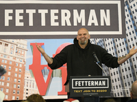 John Fetterman, Democratic candidate for Senator raises his arms as he is welcomed on stage by 600 supporters during a campaign event with C...