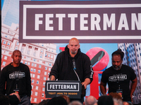 Freedom Horton and Lee Horton stand on either side of John Fetterman as he lays out the need for further criminal justice reform. The two me...
