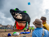 Almost at the end of the celebration of the International Kite Festival in the beach of Scheveningen in The Hague, The Holland Kite Team fle...
