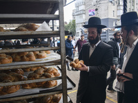 Orthodox Jewish pilgrims buy bread on the street near the tomb of Rabbi Nachman while celebrating Rosh Hashanah, the Jewish New Year,  amid...