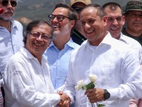 Colombian President Gustavo Petro (left) shakes hands with Venezuelan Transport Minister Ramon Velasquez (right) during the official reopeni...