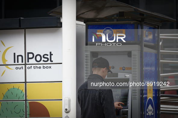 A man is seen at a Euronet ATM in Warsaw, Poland on 27 September, 2022. 