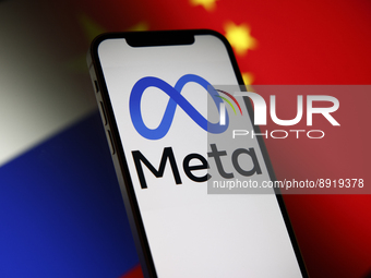 The Meta logo is seen on a mobile phone with Chinese and Russian flags in the background in this photo illustration in Warsaw, Poland on 27...
