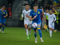 Artem Dovbyk (C) of Ukraine in action challenged by Aaron Hickey of Scotland during the UEFA Nations League 2022/23 match in Group B between...
