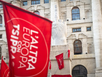 The middle finger sculpure of Maurizio Cattelan coverd of Tsipras red flag during the presentation of Italy's Tsipras List in Piazza Affari...