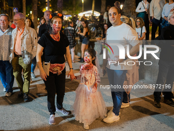 People walk through the streets of Sitges dressed as zombies during the Sitges Zombie Walk 2022, which is part of the 55th edition of the Si...