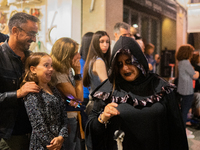 People walk through the streets of Sitges dressed as zombies during the Sitges Zombie Walk 2022, which is part of the 55th edition of the Si...