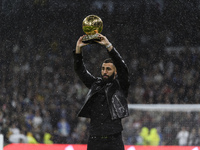 Karim Benzema of Real Madrid Cf offers the fans the Golden Ball at the Santiago Bernabéuduring a match between Real Madrid v Sevilla FC as p...