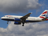 British Airways Airbus A319 aircraft as seen on final approach flying for landing at London Heathrow Airport LHR during a blue sky day with...