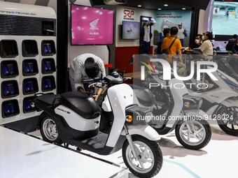 Visitors look at electric motorcycles during the Indonesia Motorcycle Show Exhibition in Jakarta, Indonesia, November 3, 2022. Indonesia is...