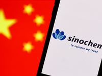 Sinochem logo displayed on a phone screen and Chinese flag displayed on a screen in the background are seen in this illustration photo taken...