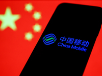 China Mobile logo displayed on a phone screen and Chinese flag displayed on a screen in the background are seen in this illustration photo t...