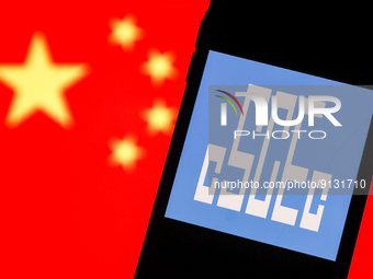 China State Construction Engineering logo displayed on a phone screen and Chinese flag displayed on a screen in the background are seen in t...