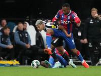 Newcastle United's Bruno Guimaraes battles for possession with Crystal Palace's  Jordan Ayew during the Carabao Cup Third Round match betwee...