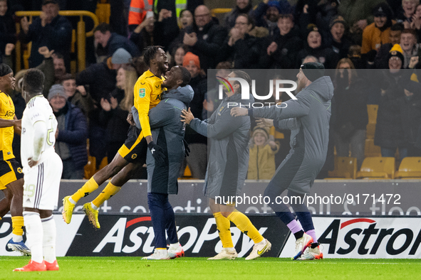 Boubacar Traore of Wolves  and substitutes celebrate scoring their side's first goal of the game during the Carabao Cup match between Wolver...