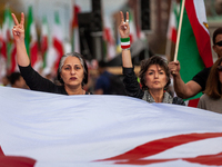 People carry a giant Iranian flag while marching for Mahsa (Zhina) Amini those people protesting her death in Iran.  After the really, peopl...
