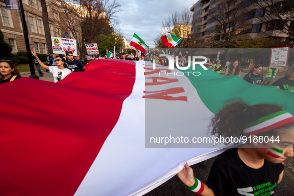 People carry a giant flag as they march for Mahsa (Zhina) Amini and people protesting her death in Iran.  After the really, people marched p...