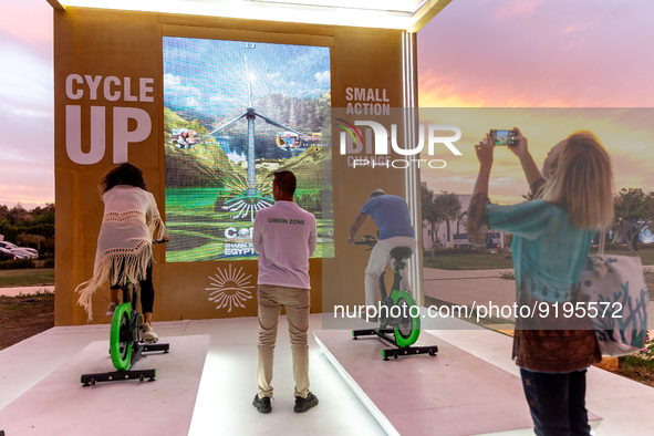 Visitors use bicycles to generate energy in the evening in the Green Zone of the COP27 UN Climate Change Conference, held by UNFCCC in Sharm...