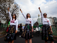 Arghavan, Roji,and Nadia (left to right) walk at the head of a march for Mahsa (Zhina) Amini and people protesting her death in Iran.  After...