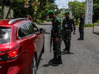 Indonesian Army personnel inspects a car at a checkpoint before entering Garuda Wisnu Kencana (GWK) Cultural Park in South Kuta, Badung, Bal...