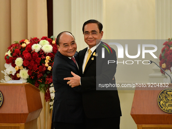 Thai Prime Minister Prayut Chan-o-cha (R) interact Vietnamese President Nguyen Xuan Phuc (L) in press conference during the official visit T...