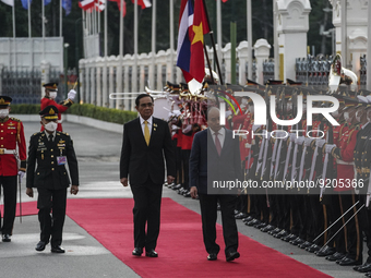 Vietnam President Nguyen Xuan Phuc is accompanied by Thai Prime Minister Prayut Chan-o-cha as they review the honor guard during a welcoming...