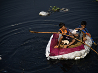 Children cross the The old Buriganga River channel at a low income area in Dhaka, Bangladesh on November 19, 2022. Buriganga river, which fl...