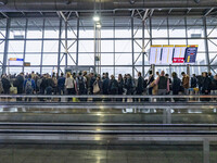 General view of the gates area in Brussels Airport with illuminated signs for the gates. Morning departing and arriving passengers are seen...