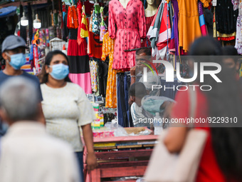 A vendor waits for customers in front of his cloth shop at Pettah main Market in Colombo on November 21, 2022. (