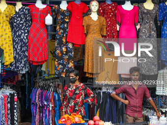 Vendors wait for customers in front of their cloth shop at Pettah main Market in Colombo on November 21, 2022. (