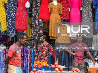 Vendors wait for customers in front of their cloth shop at Pettah main Market in Colombo on November 21, 2022. (