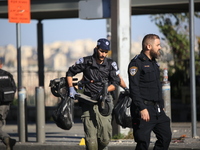 Israeli police inspect the scene of an explosion at a bus stop in Jerusalem, Wednesday, Nov. 23, 2022. Two blasts have gone off near bus sto...