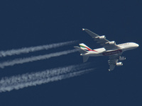 Emirates Airbus A380 double decker passenger aircraft as seen flying in the blue sky over the Netherlands in Europe, the route EK22 from Man...