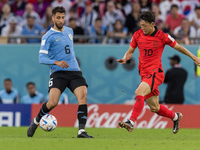 Rodrigo Bentancur , Jaesung Lee  during the World Cup match between Uruguay v Korea Republic in Doha, Qatar, on November 24, 2022. (