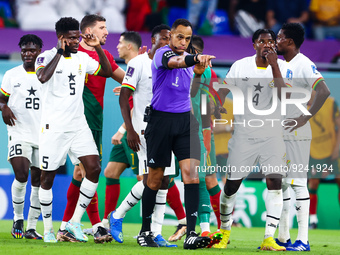 Ismail Elfath referee, Thomas Partey (GHA), Mohammed Salisu (GHA) during the World Cup match between Portugal v Ghana  , in Doha, Qatar, on...
